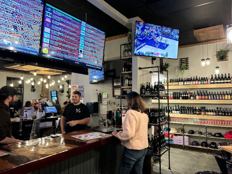 woman ordering at the Percent Tap house counter