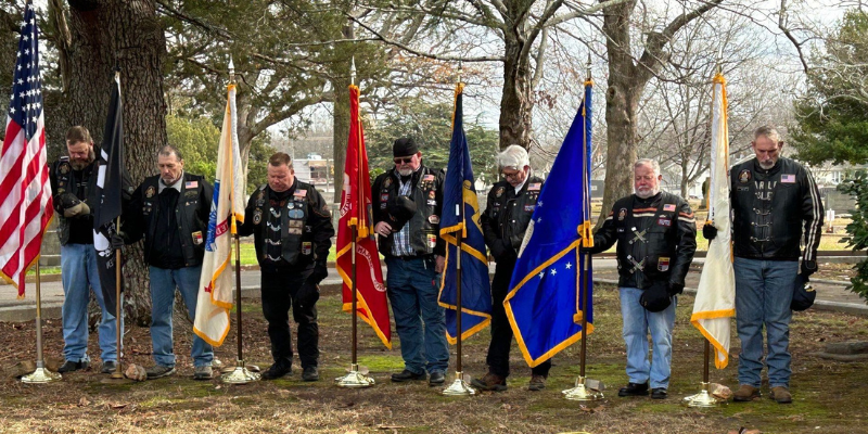 Veterans holding flags at Wreaths Across America Ceremony