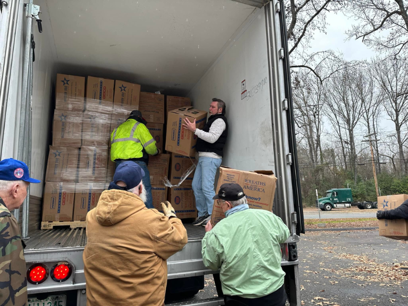 men unloading a truck for the Wreaths Across America ceremony