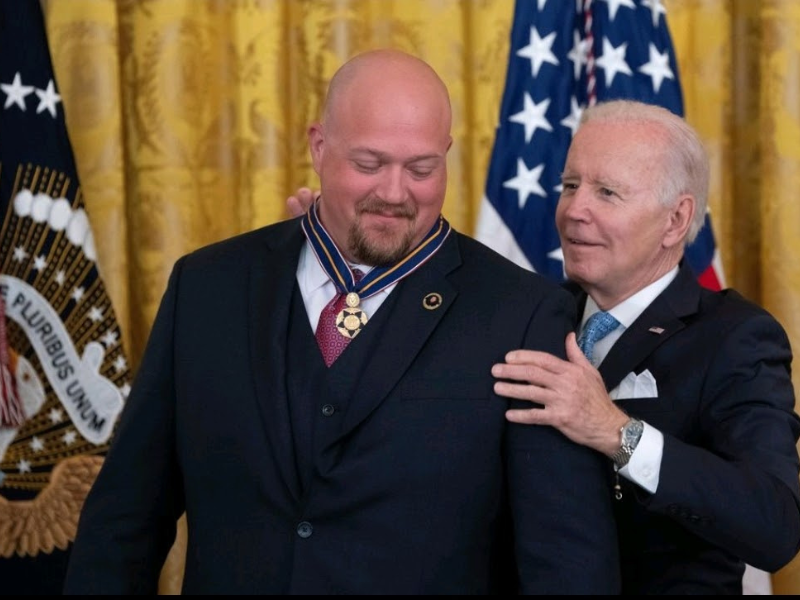 Officer Kyle Baker receiving medal from President Biden